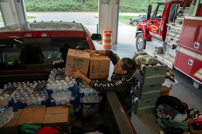 A volunteer unloads relief supplies in North Carolina on October 3, 2024, after the passage of Hurricane Helene made drinking water a valuable commodity