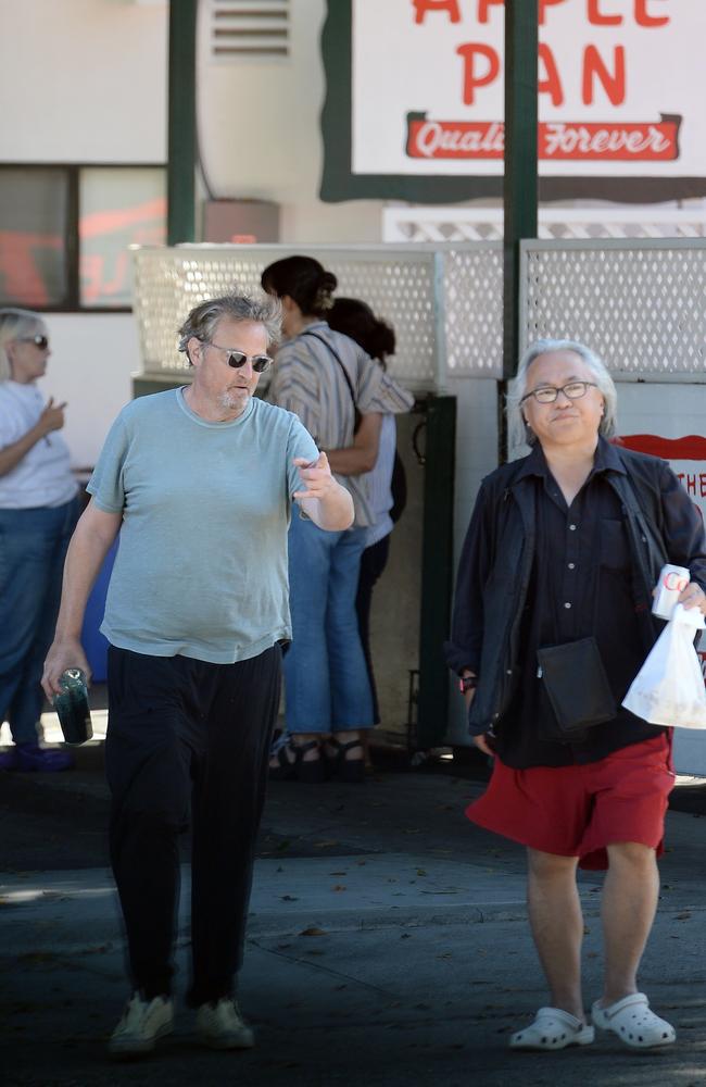 He was chatting to a friend as they left the restaurant. Picture: TheImageDirect.com