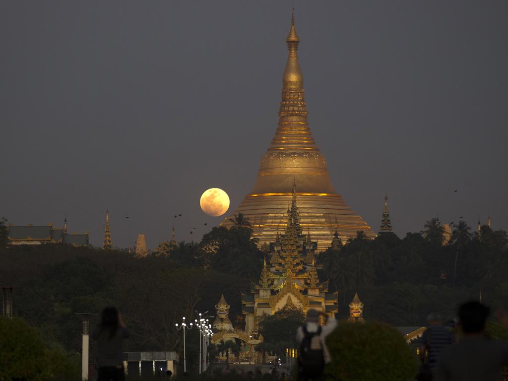 The moon rises behind Myanmar landmark Shwedagon pagoda, Wednesday, Jan.31, 2018, in Yangon, Myanmar. The moon put on a rare cosmic show Wednesday: a red blue moon, super big and super bright.It’s the first time in 35 years a blue moon has synced up with a supermoon and a total lunar eclipse, or blood moon because of its red hue. Picture: AP