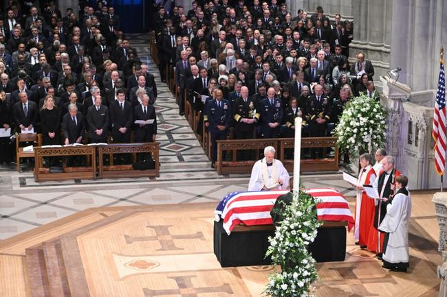 Members of the clergy pray over the casket of former US president Jimmy Carter during his state funeral at Washington National Cathedral, as all five living US presidents look on