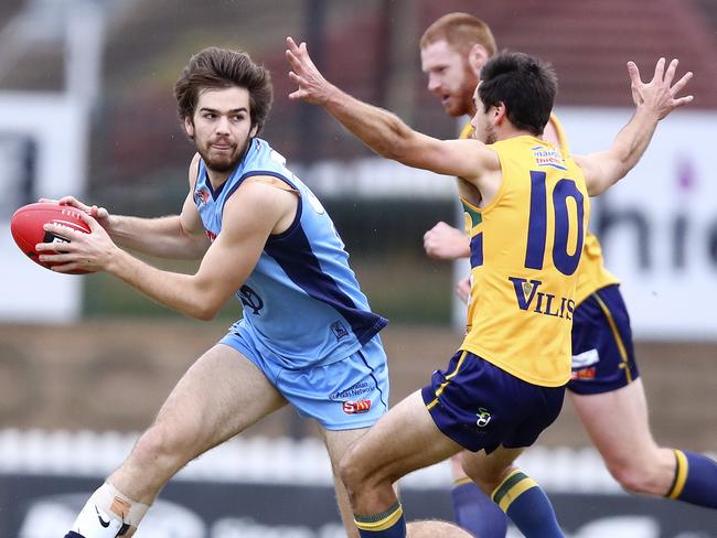 Sturt’s Thomas Read looks to handpass past Eagles’ Chris Hall. Picture: SARAH REED