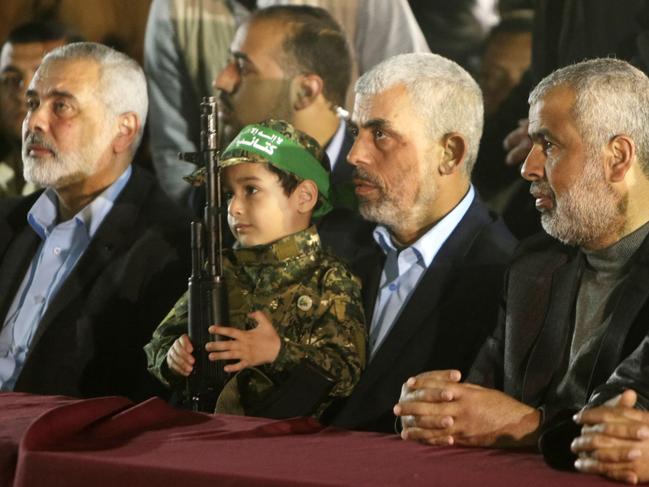 Yahya Sinwar (2nd R), the new leader of the Hamas Islamist movement in the Gaza Strip and senior political leader Ismail Haniyeh (L) sit next to the son of Mazen Faqha, a Hamas leader who was shot dead by unknown gunmen in the Gaza Strip. Picture: AFP