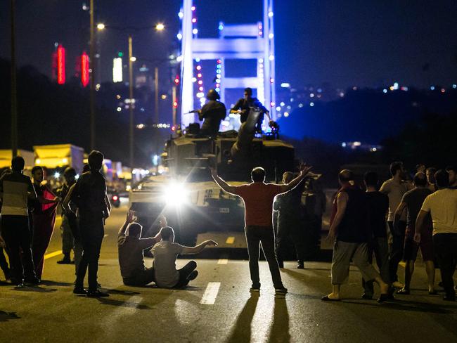 People take over a tank near the Fatih Sultan Mehmet bridge during clashes with military forces in Istanbul on July 16, 2016. Istanbul’s bridges across the Bosphorus, the strait separating the European and Asian sides of the city, have been closed to traffic. Picture: AFP PHOTO / GURCAN OZTURK
