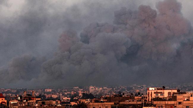 Smoke billows over Khan Yunis in the southern Gaza Strip during Israeli bombardment on January 16, 2024, amid ongoing battles between Israel and the Palestinian militant group Hamas. The staggering suffering, death and destruction of six months of war since Hamas's October 7 attack has widened the gulf between Israelis and Palestinians, leaving both feeling that the prospect of peace is ever more elusive. (Photo by Mahmud Hams / AFP)