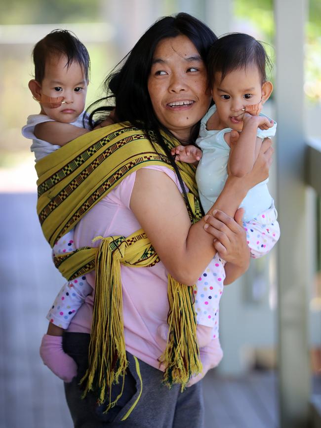 Bhumchu Zangmo carries Nima (left) and Dawa (right) in the traditional Bhutanese way. Picture: Alex Coppel 