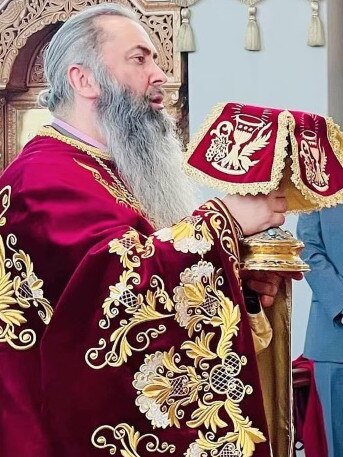 Father John Christodoulos with the communion chalice at St Andrew Parish Picture: Supplied