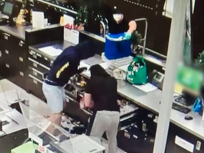 Three bandits ram-raid a Woolies store in the upmarket suburb of Hamilton and steal drawers of cigarettes. Picture: Supplied / QPS