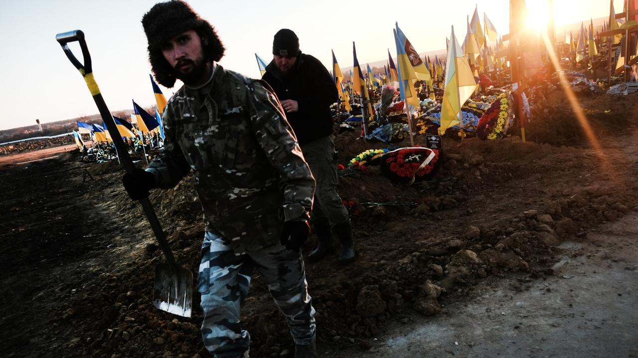 A man digging graves walks through a Kharkiv cemetery where a large and growing section is devoted to soldiers in Kharkiv, Ukraine. Picture: Spencer Platt/Getty Images.