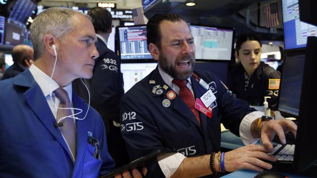 Trader Timothy Nick, left, and Michael Pistillo work the floor of the New York Stock Exchange. Picture: AP