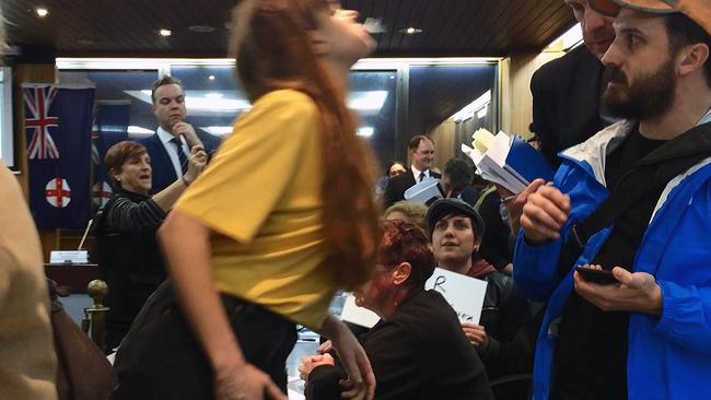 Ugly scenes as protester Nicky Minus spits on Inner West Council administrator Richard Pearson. Picture: Bryant Hevesi