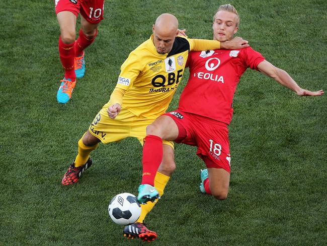 Adelaide’s James Jeggo and Perth’s Ruben Zadkovich fight for the ball.