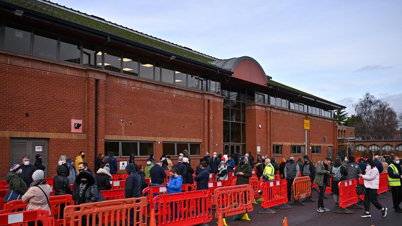 Members of the public queue outside a vaccine centre in Glasgow, United Kingdom.