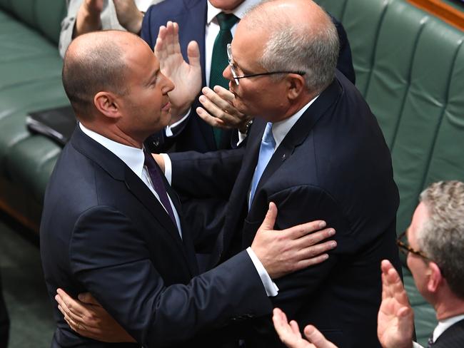 Treasurer Josh Frydenberg is congratulated by Prime Minister of Australia Scott Morrison after delivering the Budget in the House of Representatives. Picture: Getty Images