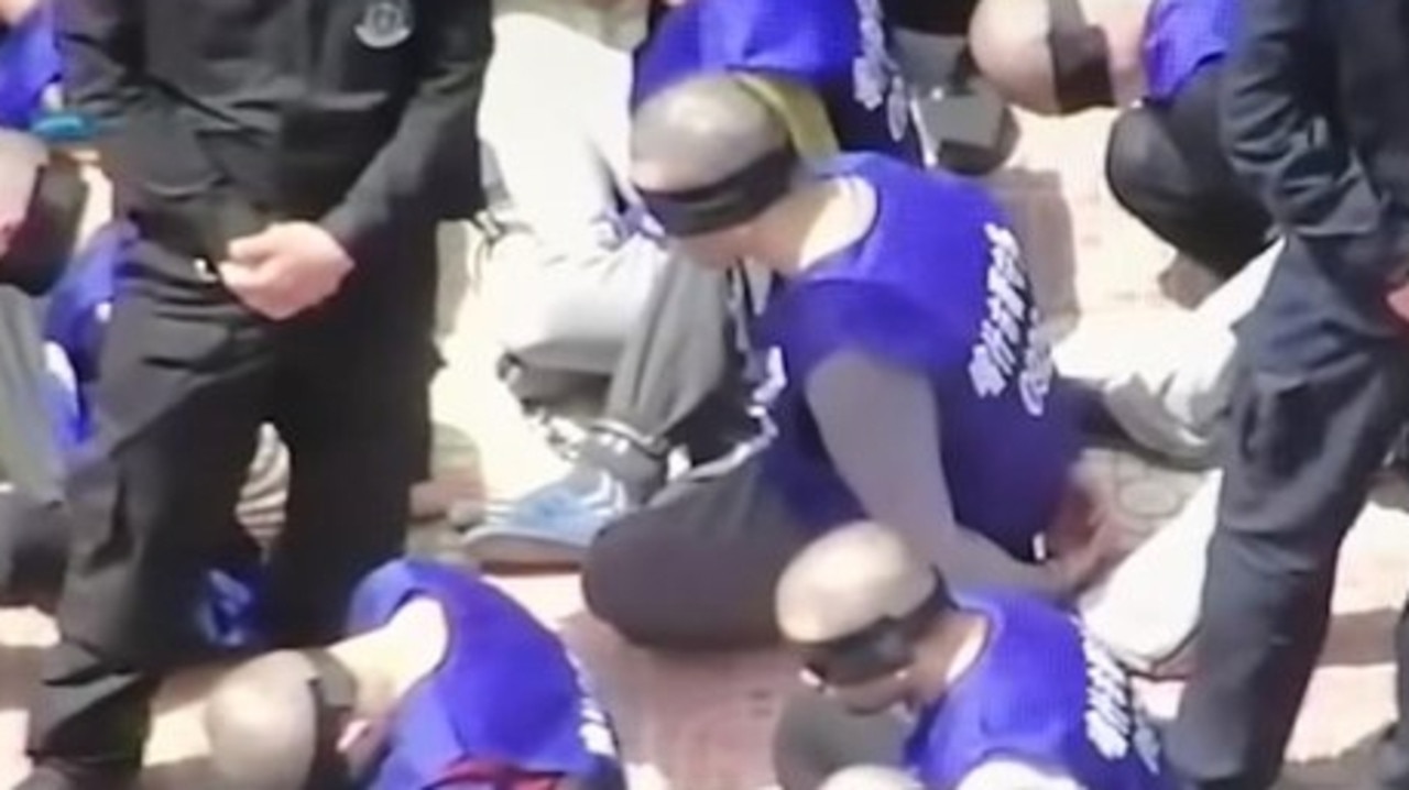 Drone footage showing blindfolded and shackled Uighurs. Picture: YouTube