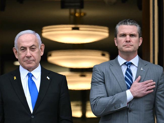 TOPSHOT - US Secretary of Defense Pete Hegseth (R) places hand on heart as he welcomes Israeli Prime Minister Benjamin Netanyahu to the Pentagon in Arlington, Virginia, on February 5, 2025. (Photo by Jim WATSON / AFP)