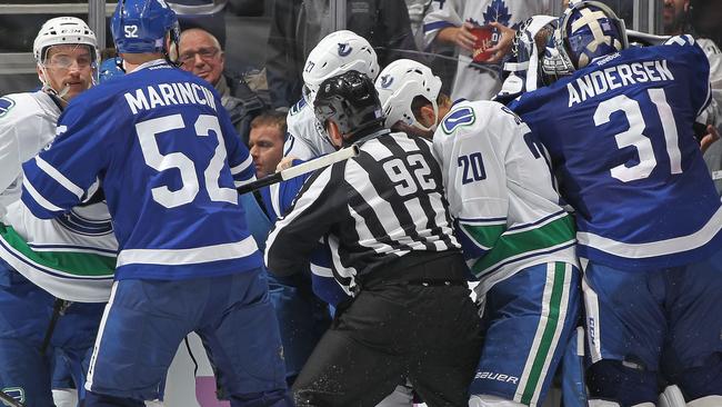 Frederik Andersen #31 of the Toronto Maple Leafs leaves his crease to join in a fight against Ryan Miller #30 of the Vancouver Canucks.