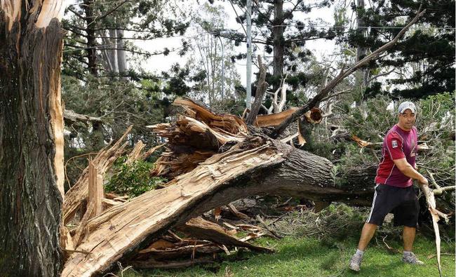 A resident helps the clean-up on Brisbane Terrace in Goodna on Monday morning.