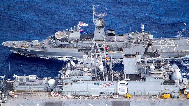 The USS America (foreground) conducts a replenishment at sea off the coast of Queensland, in a historic moment for the American amphibious assault ship, during Exercise Talisman Sabre 2021. A biennial exercise since 2005, TS21 aims to test Australian interoperability with the US and other participating forces in complex war fighting scenarios. Picture: LSIS Ernesto Sanchez/ADF