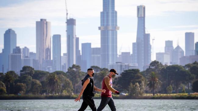 Masked walkers exercise at Albert Park. Picture: Mark Stewart