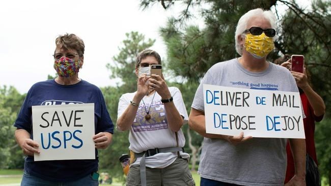 A group of protestors hold a demonstration in front of Postmaster General Louis DeJoy's home in Greensboro, North Carolina. Picture: AFP.