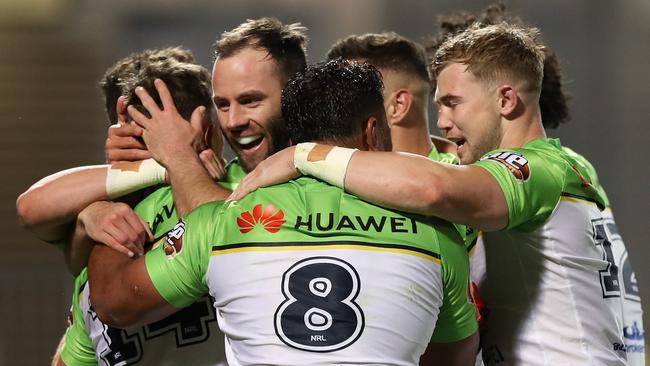 Kai O'Donnell of the Raiders celebrates with teammates after scoring a try during the round 20 NRL match between the Cronulla Sharks and the Canberra Raiders at Netstrata Jubilee Stadium.