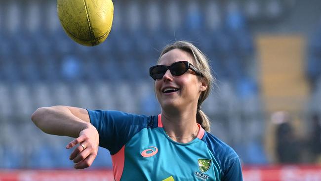 Australia's Ellyse Perry tosses up a rugby ball before the start of the final day play of the women's Test cricket match between India and Australia at the Wankhede Stadium in Mumbai on December 24, 2023. (Photo by Indranil MUKHERJEE / AFP) / -- IMAGE RESTRICTED TO EDITORIAL USE - STRICTLY NO COMMERCIAL USE --