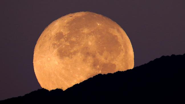 This super moon was shot setting over the Huachuca Mountains in Sierra Vista, Arizona. The super moon occurs when the moon is at its closest point to the earth and appears larger in the sky than normal. It was shot on the morning of the super-blood moon, September 27 2015. The pre-dawn purple hews give an ethereal impression.