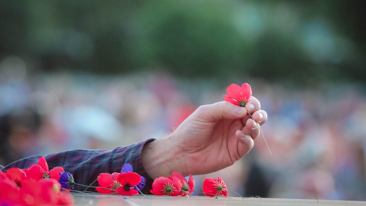 Poppys being laid at The Dawn Service at Darwins Cenotaph commemorating ANZAC Day 2021. Picture Glenn Campbell