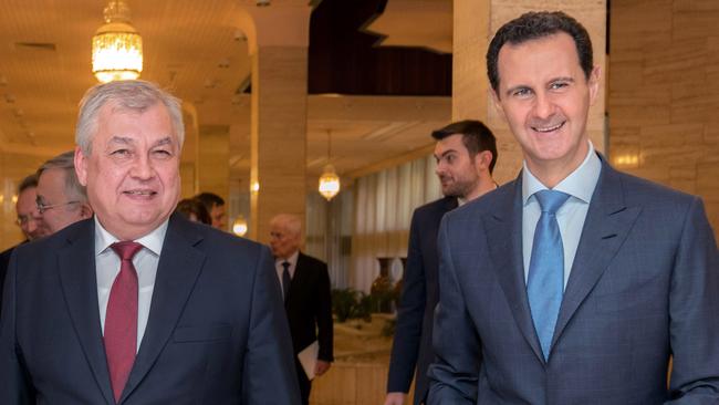 Bashar al-Assad, right, with Russian special envoy Alexander Lavrentiev.