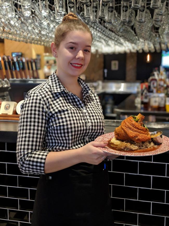 Maddie from The Bavarian Rouse Hill with the restaurant's famous Crispy Pork Knuckle.