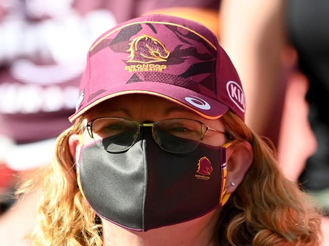 Southeast Queenslanders will have to wear masks for another week, including while seated at sporting matches. Picture: Bradley Kanaris/Getty Images