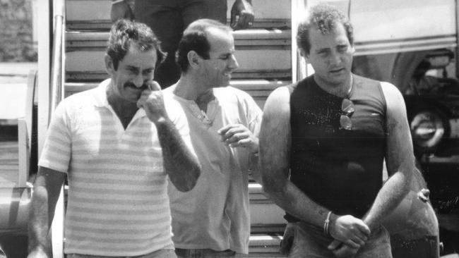 Jonathon Bakewell, right, is escorted by NT Police from a plane at the Darwin Airport in 1988 after he murdered Anne-Marie Culleton.