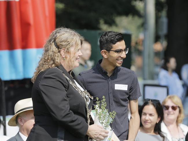 New Australian citizens receiving their certificate and a plant from Lord Mayor Anna Reynolds during the Australia Day celebrations at Sandy Bay in Tasmania. Picture: Mathew Farrell