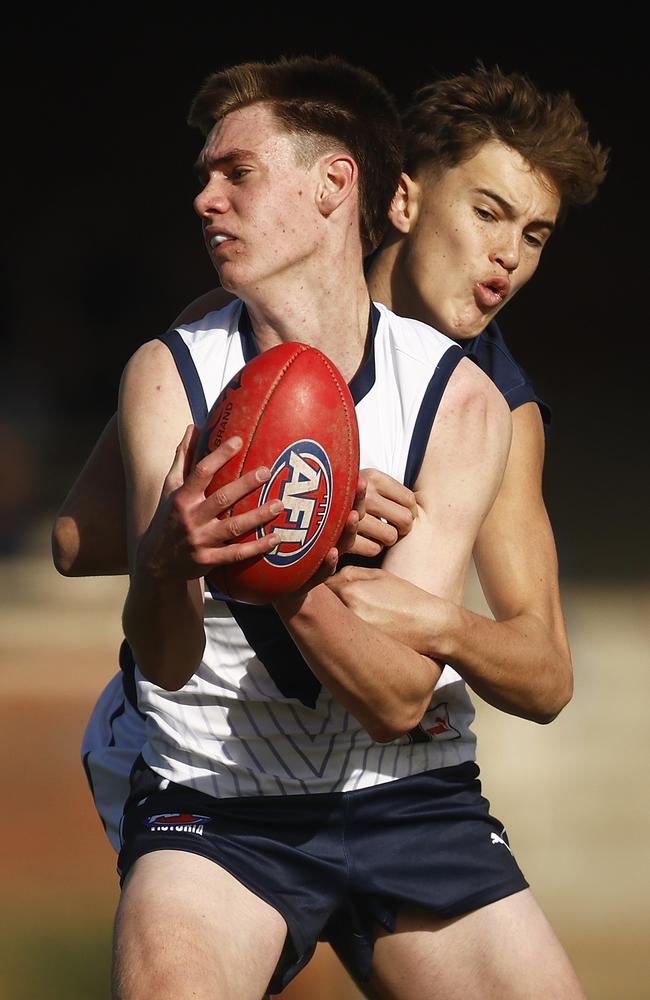 MELBOURNE, AUSTRALIA - JUNE 10: Geordie Richardson of Victoria Country is tackled by Jack Ison of Victoria Metro during the AFL National Development Championships U16 match between Victoria Country and Victoria Metro at Trevor Barker Beach Oval on June 10, 2023 in Melbourne, Australia. (Photo by Daniel Pockett/AFL Photos/via Getty Images)