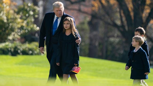 Donald Trump, with his grandchildren, Arabella, Theodore, and Joseph, arrives at the White House after a weekend at Camp David. Picture: AFP.