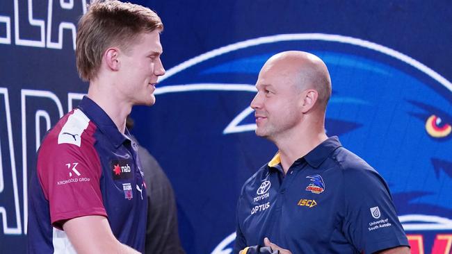 Sixth AFL draft pick Fischer McAsey is presented with his new jersey by Adelaide Crows coach Mathew Nicks. Picture: AAP Image/Michael Dodge