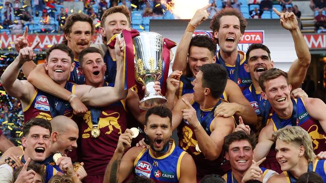 Brisbane Lions players celebrate with the premiership cup after winning the AFL Grand Final after defeating the Sydney Swans at the MCG. Picture Lachie Millard