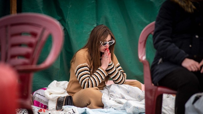 A woman sits at a camp near the Ukrainian-Slovakian border.