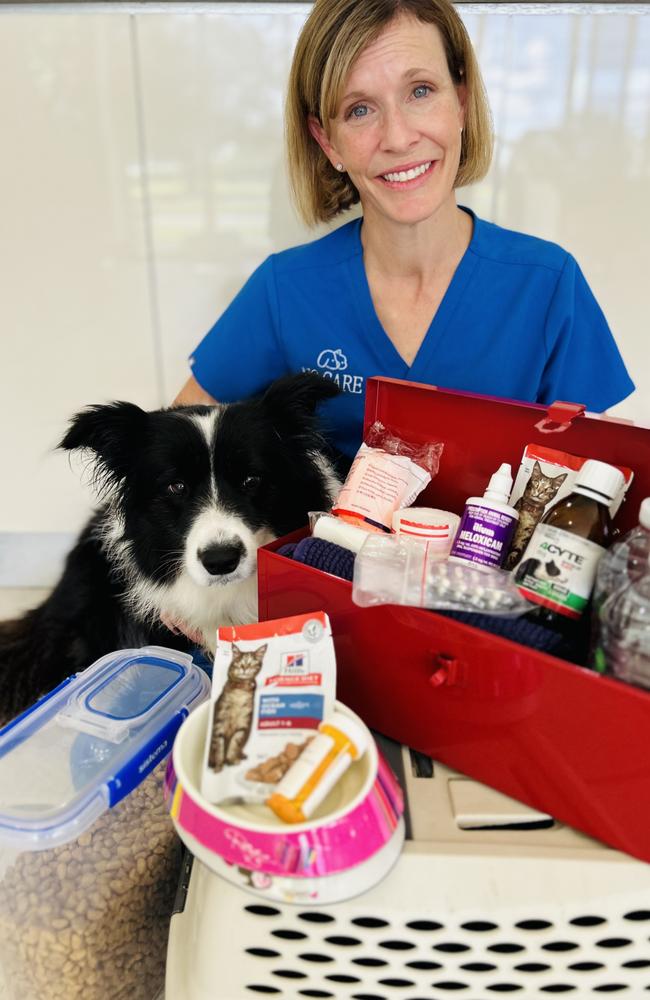 Dr Taleta Hompas with her furry sidekick shows off an example of the items that should be packed in their pet’s cyclone emergency kit. Picture: NQ Care.