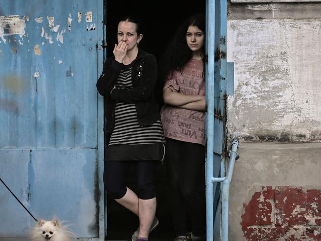 Women stand at the door of their apartment building in the city of Lysychansk, a city without electricity and water, in the eastern Ukrainian region of Donbas. Picture: AFP