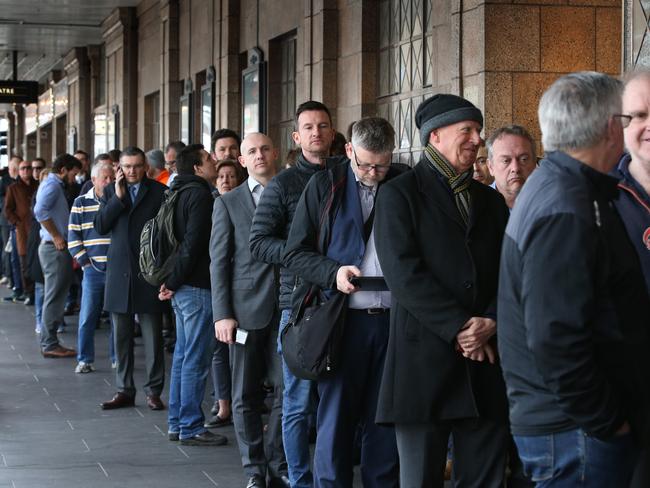 Footy fans queuing for tickets on Exhibition Street. Picture: David Caird