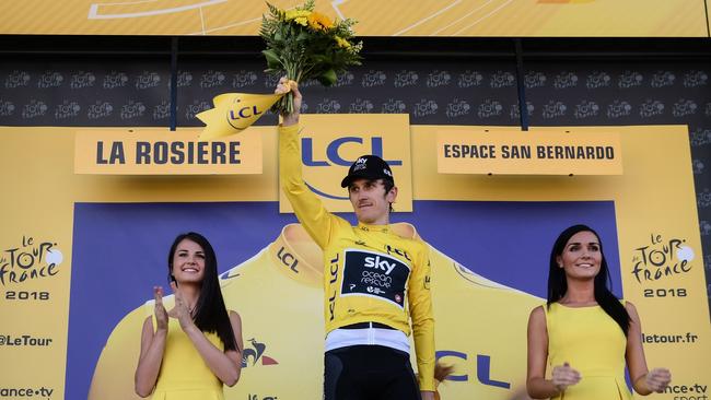 Great Britain's Geraint Thomas, wearing the overall leader's yellow jersey, celebrates on the podium. Photo: AFP