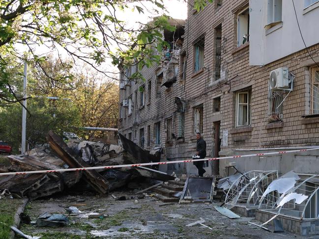 A local resident takes his belongings out of a damaged residential building after a drone attack in Zaporizhzhia on May 2, 2025, amid the Russian invasion of Ukraine. Picture: AFP