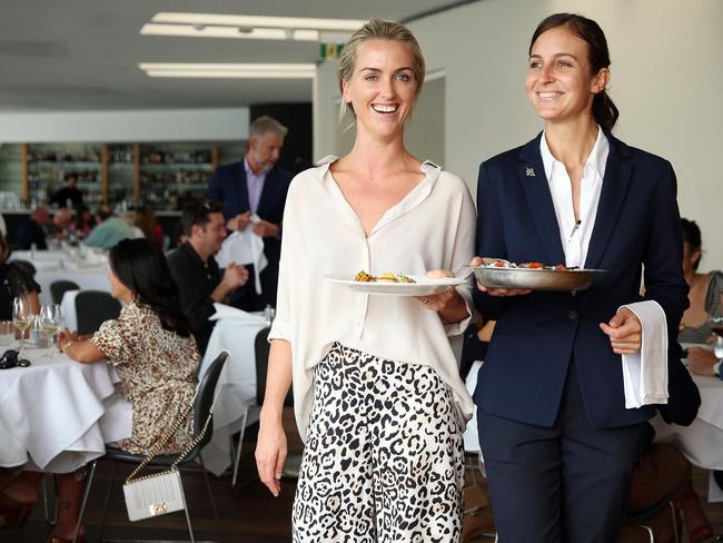 Kate McMahon (left) and Eleonora Vaccarini serving food at Catalina Restaurant in Rose Bay, which is considering legal waivers for take home food. Picture: Sam Ruttyn