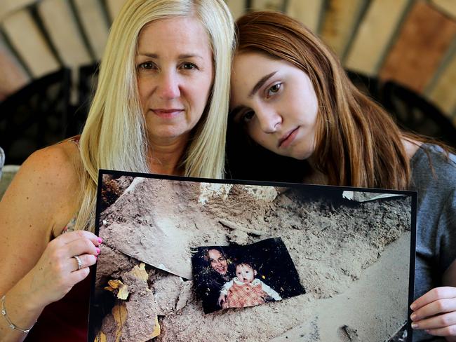 Jennifer Robinson with her daughter Isabelle at their home in Parkland, Florida, and the photo of them recovered from the September 11 attacks. Picture: Nathan Edwards