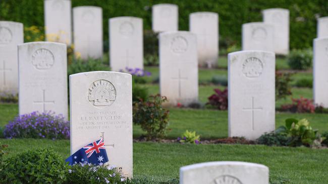 An Australian flag is placed next to a grave stone at the Australian National Memorial at Villers-Bretonneux. Picture: AAP.