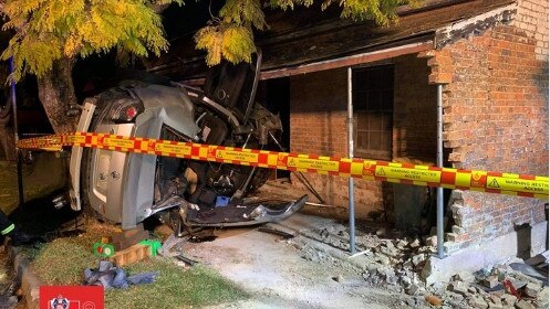 A car driven by David Collisson flipped and crashed into a house at Marsden St Parramatta. Picture: Fire and Rescue NSW