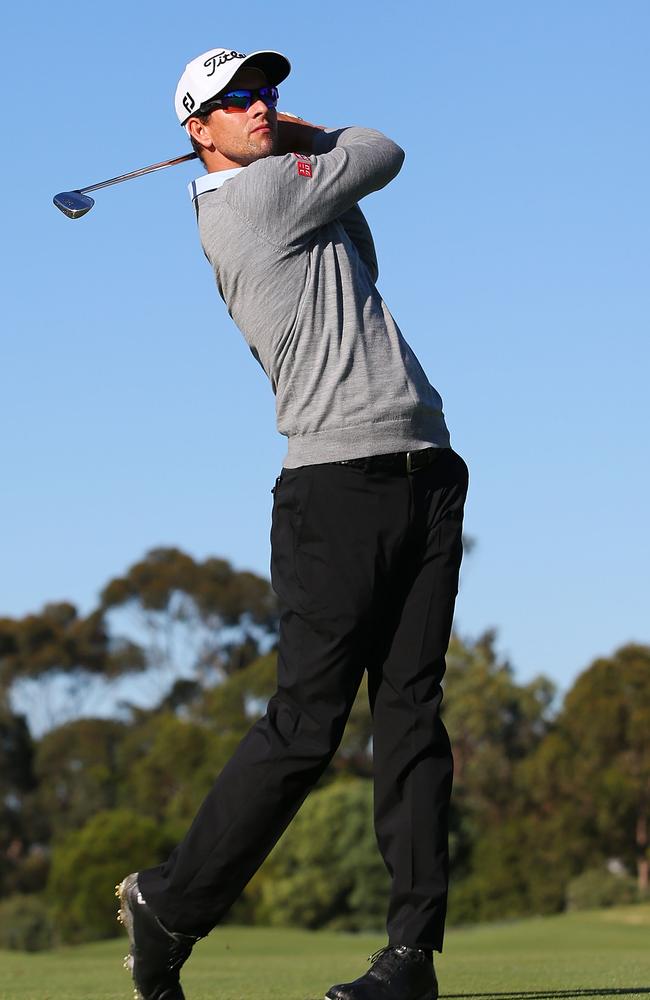 Adam Scott hits an approach shot ahead of the 2014 Australian Masters