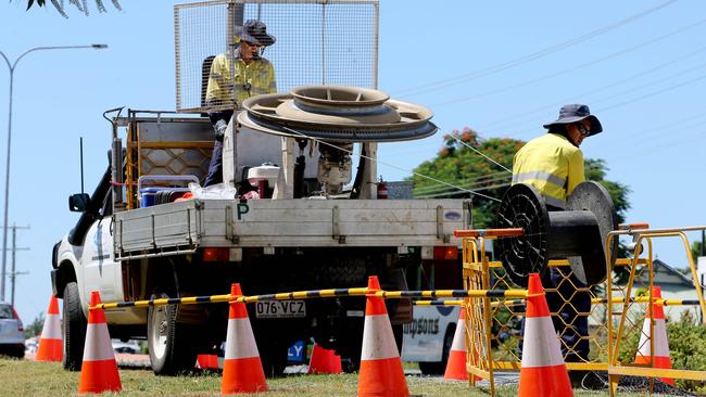 Workers laying fibre NBN cable along Dohle's Rocks Rd. Picture: Chris Higgins