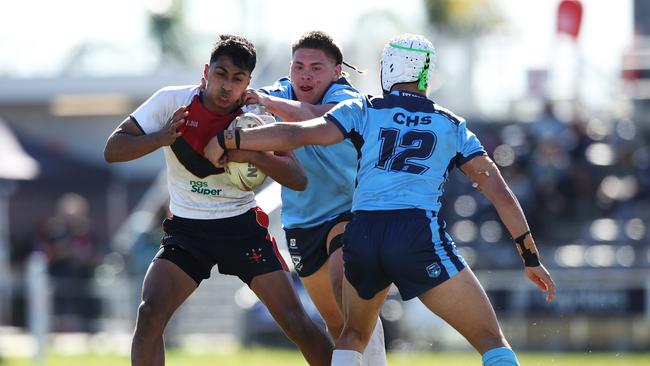 NSW CIS's Ashton Large is tackled during the under 15 ASSRL schoolboy rugby league championship grand final between NSW CHS v NSW CIS.